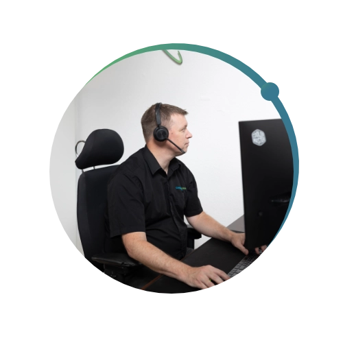 Conquest wildman team member working on the computer using a VOIP headset