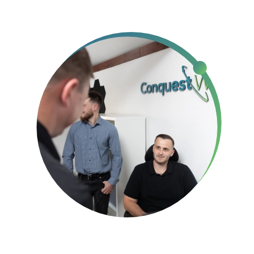 Conquest Wildman team members in the office talking